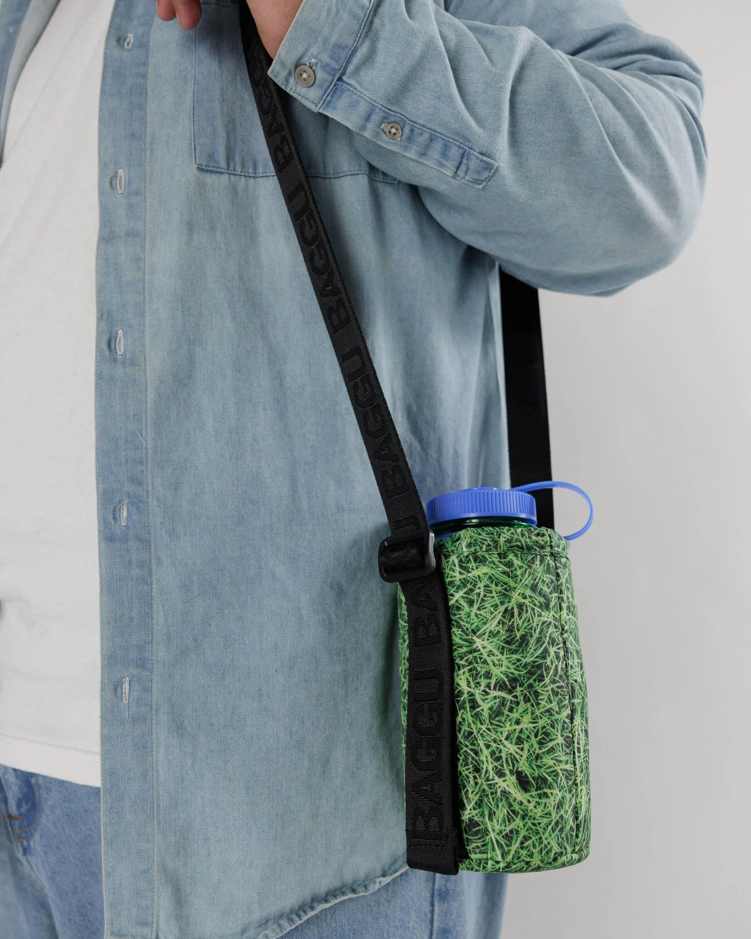 Puffy Water Bottle Sling with Grass Graphic Pattern with Adjustable Black Crossbody Strap with De-bossed "BAGGU" Text 