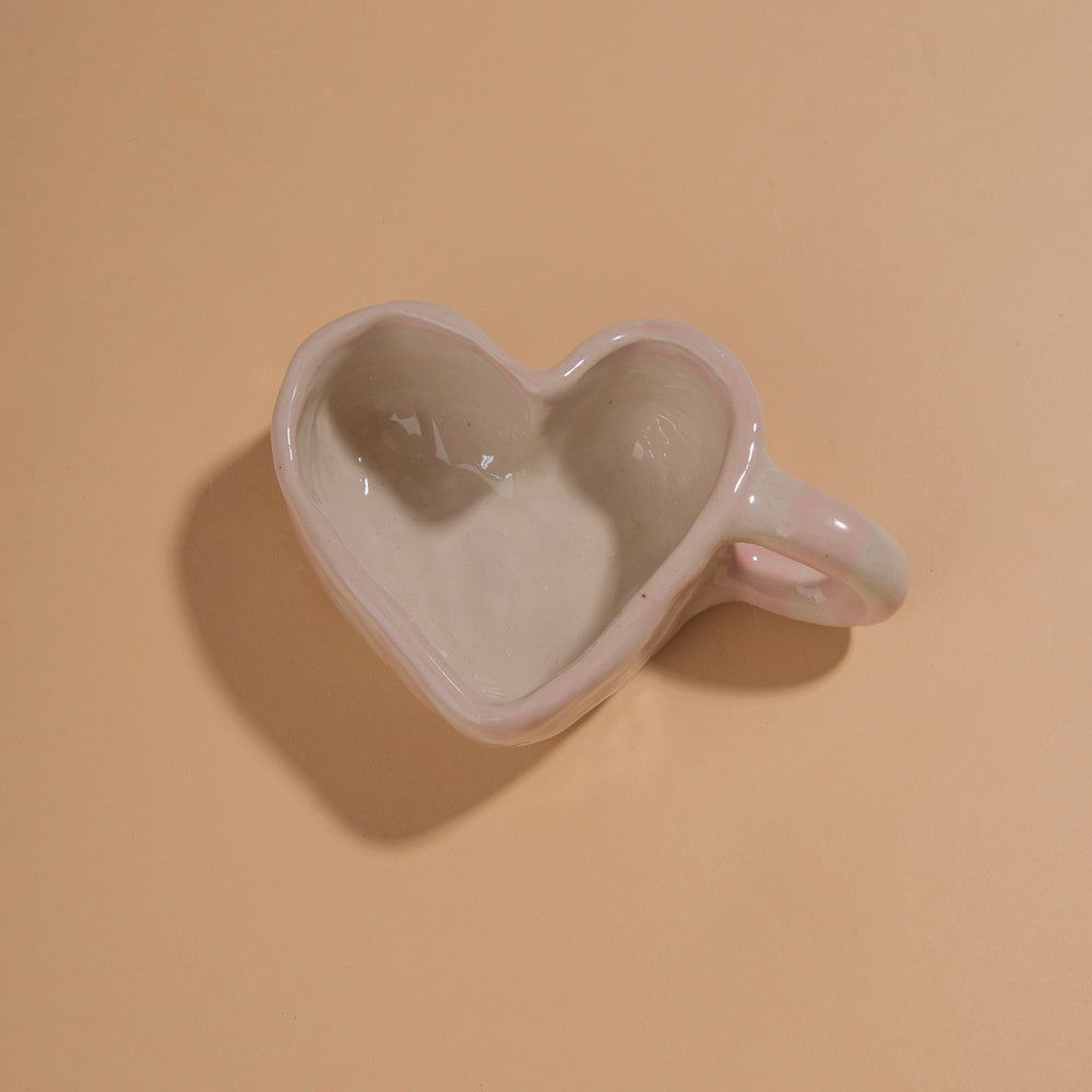 Ceramic heart shaped mug with ceramic heart shaped saucer with painted pink gingham pattern