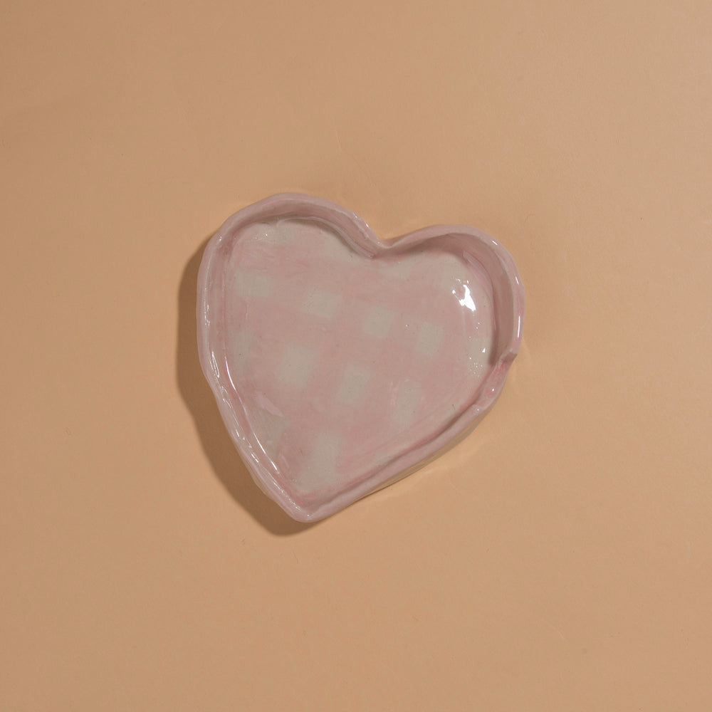 Ceramic heart shaped mug with ceramic heart shaped saucer with painted pink gingham pattern