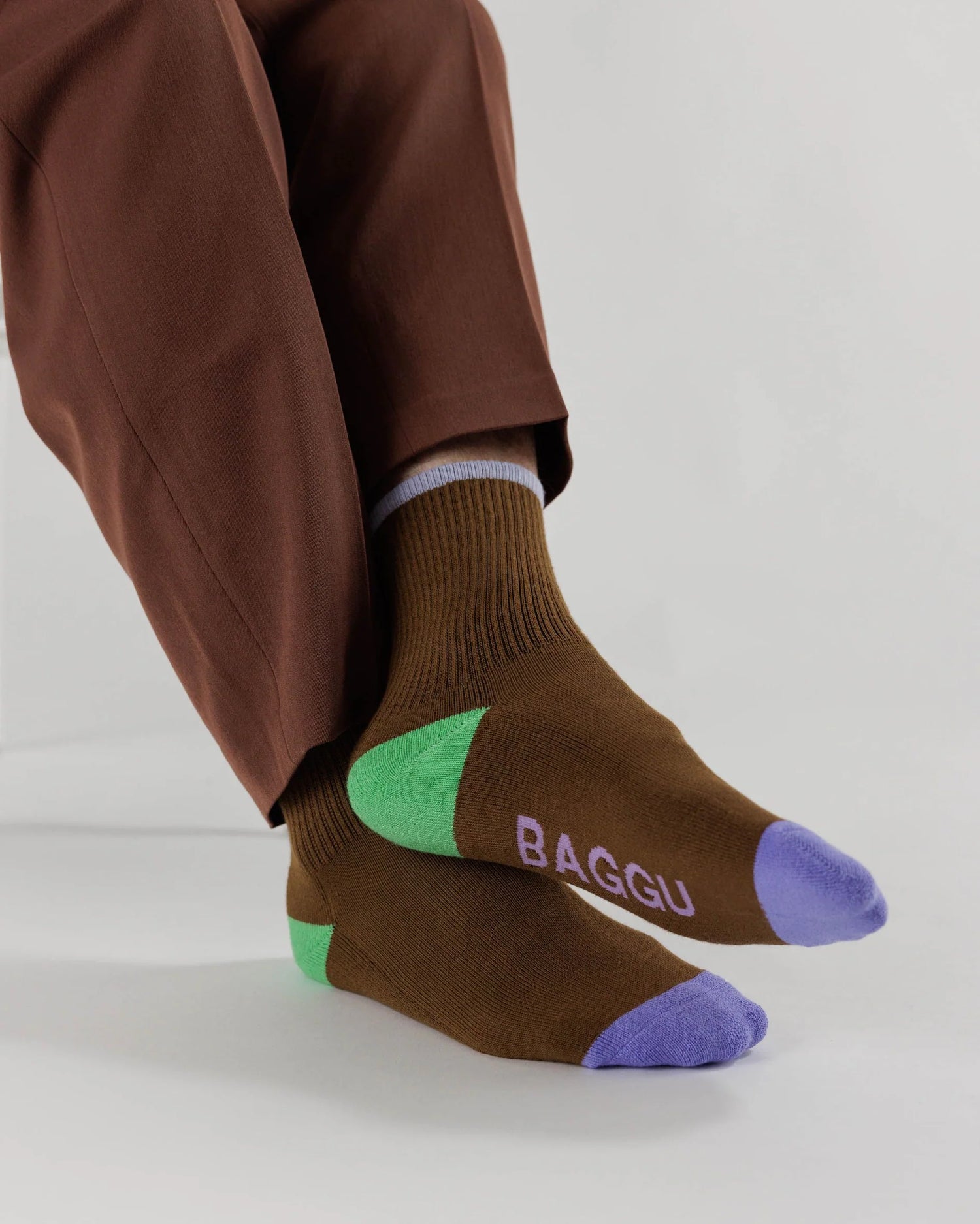 Brown Socks with Lilac Ankle Stripe, Green heel, Radiant Purple colour blocked toes, dusty pink "BAGGU" text on bottom of feet