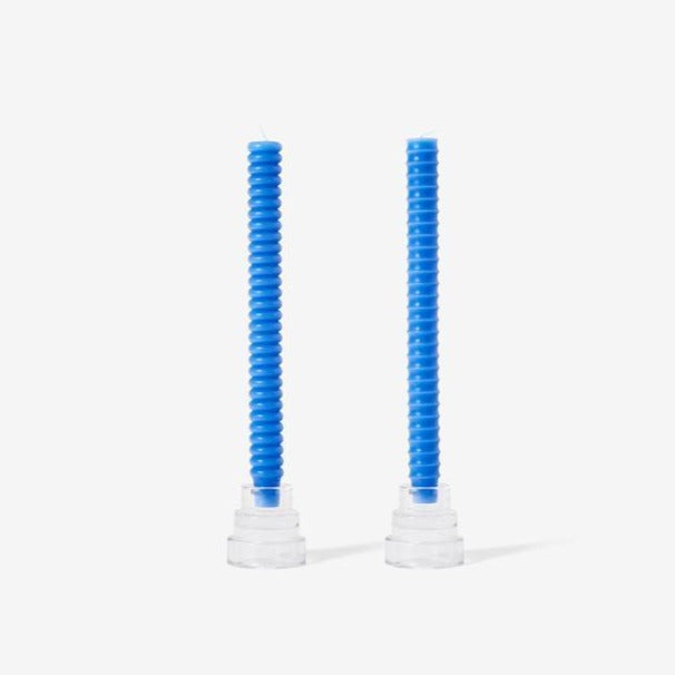 Two cobalt blue taper candles with ribbed texture